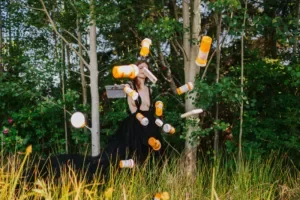 Woman tossing pill boxes, representing shift from opioids to new non-opioid pain treatments.