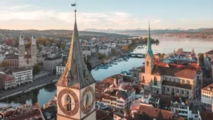 Drone shot of central Zurich skyline, lakefront and historic old town rooftops