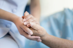 ing-hospital-bed-older-woman-helping-hands-300x200.jpg