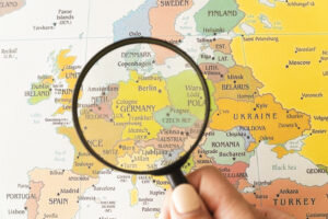 many-showed-map-helped-by-magnifying-glass-300x200.jpg